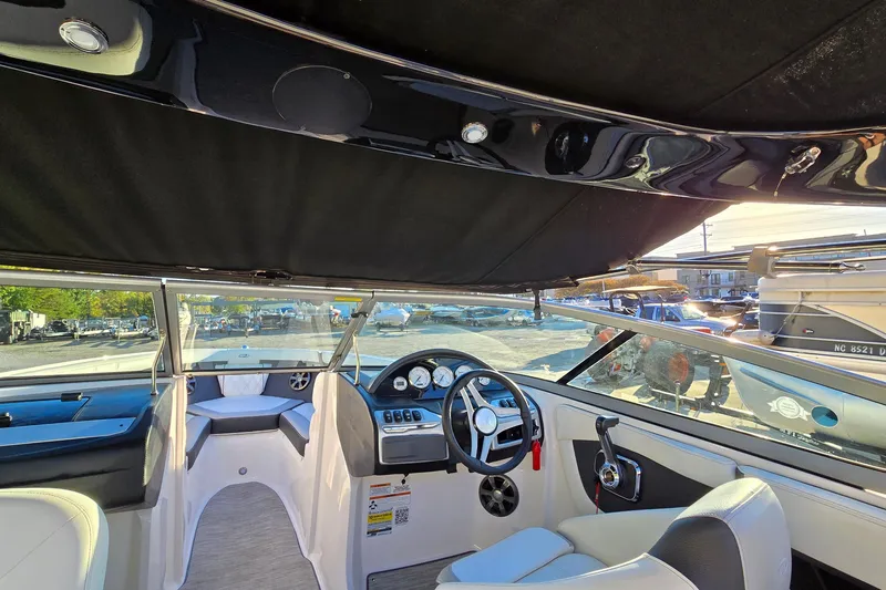 Slide: The Image of Interior view of a 2019 Regal 2000 ES Bowrider boat, showcasing steering and seating area. - 58