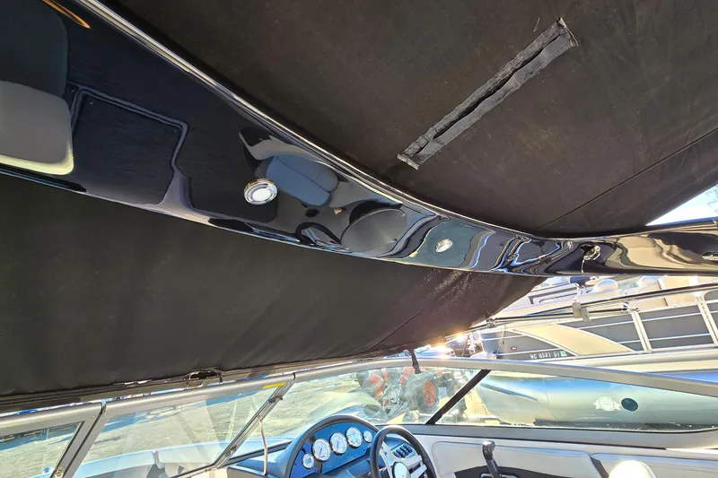 Slide: The Image of Interior view of a 2019 Regal 2000 ES Bowrider boat with dashboard and canopy. - 60