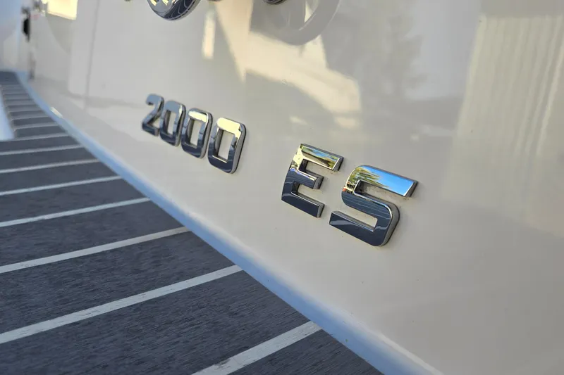 Slide: The Image of Close-up of 2019 Regal 2000 ES Bowrider boat emblem on sleek white surface. - 63