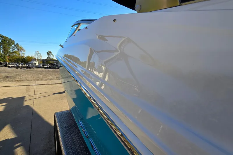 Slide: The Image of 2019 Regal 2000 ES Bowrider boat side view, showcasing sleek design and glossy finish. - 8