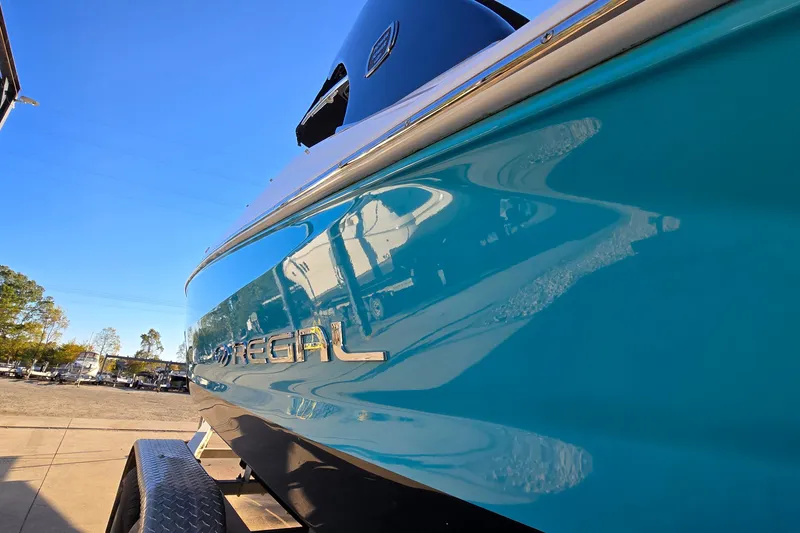 Slide: The Image of 2019 Regal 2000 ES Bowrider boat with sleek blue exterior on a trailer. - 9
