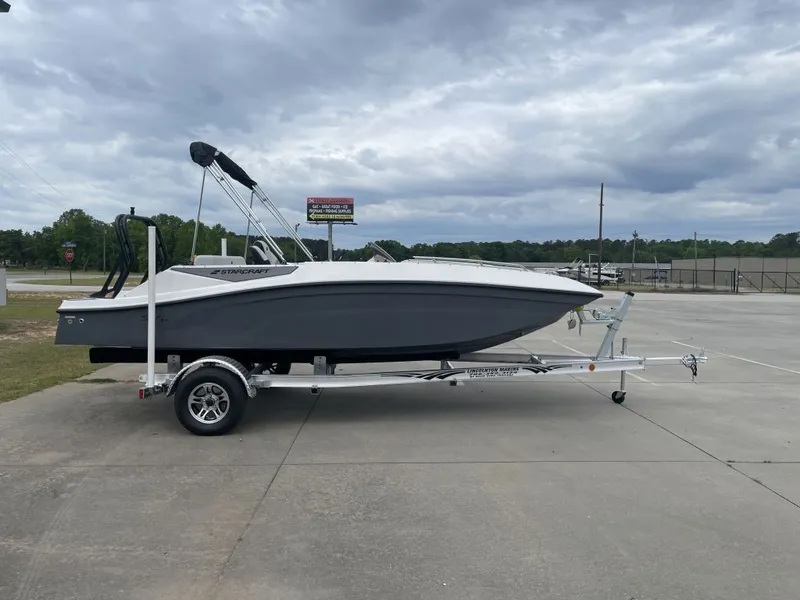 The Image of 2026 Starcraft SV 18 OB boat on trailer, gray hull, cloudy sky. - 1