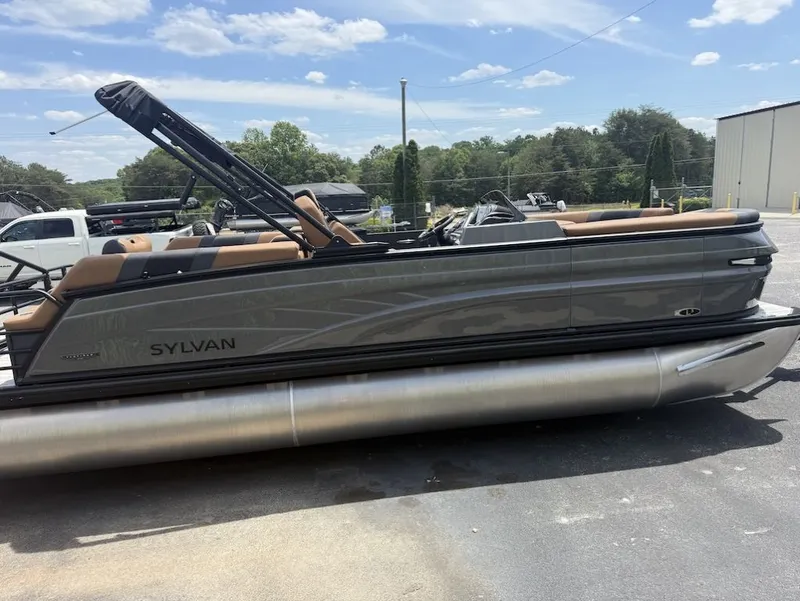 Slide: The Image of 2026 Sylvan L-3 LZ DH pontoon boat parked outdoors. - 3