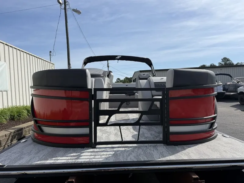 Slide: The Image of 2026 Starcraft SLS 3 Q DH pontoon boat, red and black, in parking lot. - 4
