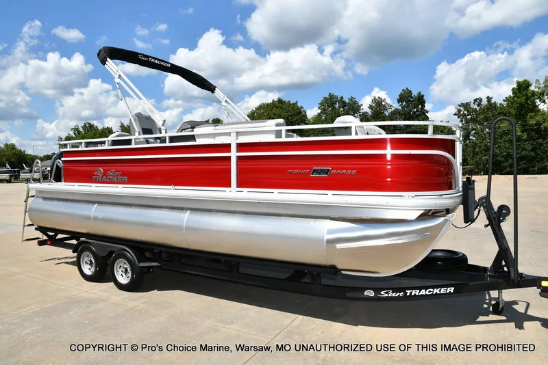 The Image of 2026 Sun Tracker Fishin' Barge 22 XP3 Tri-Toon on trailer. - 1