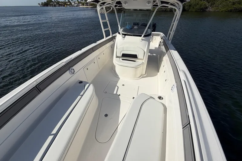 Slide: The Image of 2014 Wellcraft 35 Scarab Tournament boat with spacious deck and seating, on calm water. - 11