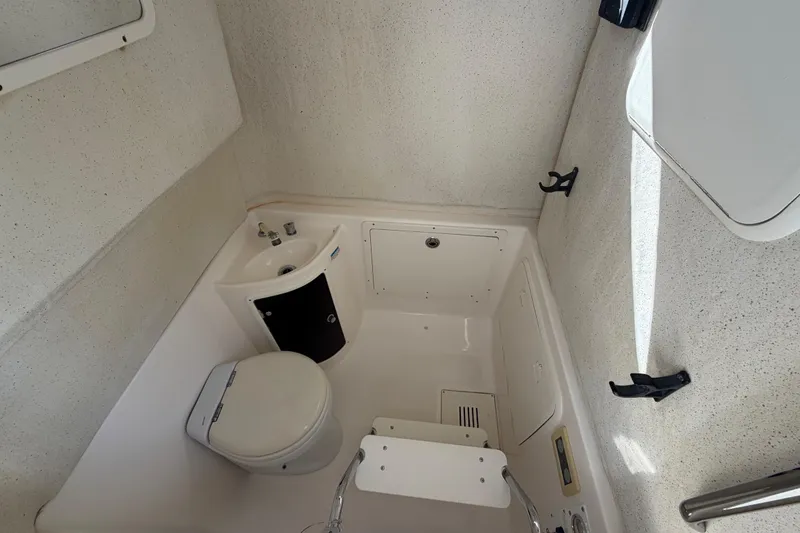 Slide: The Image of 2014 Wellcraft 35 Scarab Tournament boat bathroom with toilet and sink. - 12