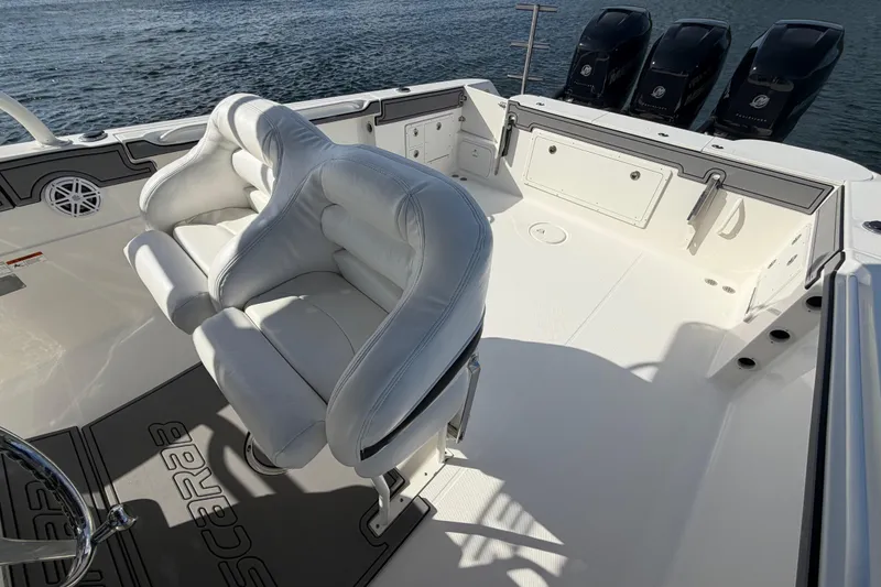 Slide: The Image of 2014 Wellcraft 35 Scarab Tournament boat interior with white seating and triple Mercury engines. - 13