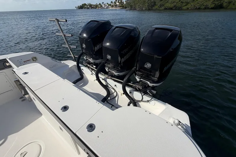 Slide: The Image of 2014 Wellcraft 35 Scarab Tournament with triple Mercury outboard engines on open water. - 15