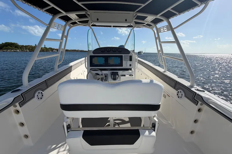 Slide: The Image of 2014 Wellcraft 35 Scarab Tournament boat interior with helm, ocean view, and clear sky. - 17