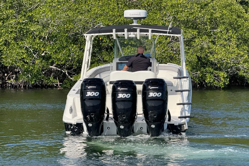 Slide: The Image of 2014 Wellcraft 35 Scarab Tournament boat with triple 300 horsepower engines navigating waterway. - 3