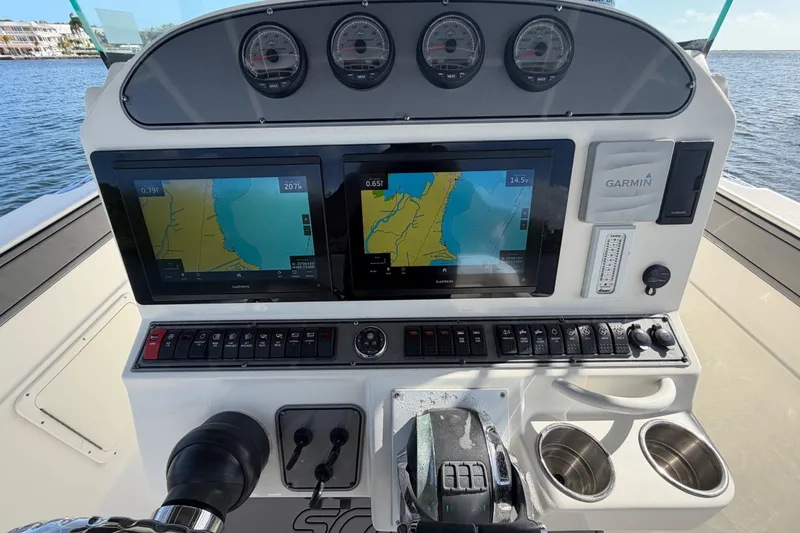 Slide: The Image of Dashboard of a 2014 Wellcraft 35 Scarab Tournament boat with Garmin navigation displays. - 7