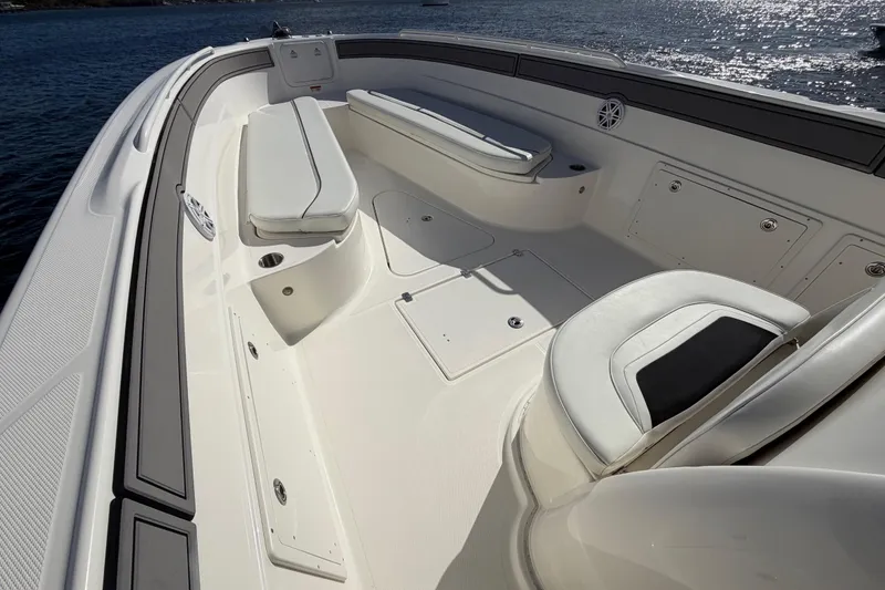 Slide: The Image of 2014 Wellcraft 35 Scarab Tournament boat interior with cushioned seating and storage compartments. - 8