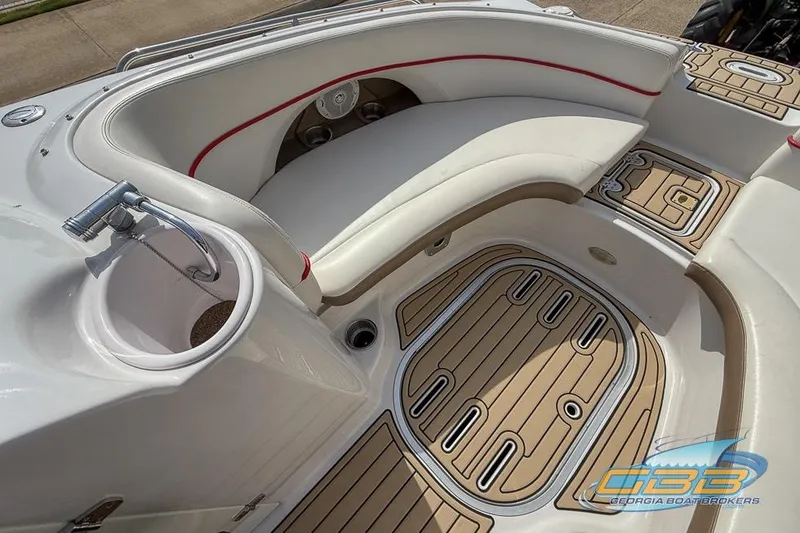 Slide: The Image of 2008 Four Winns F224 boat interior with white seating and teak-style flooring. - 12