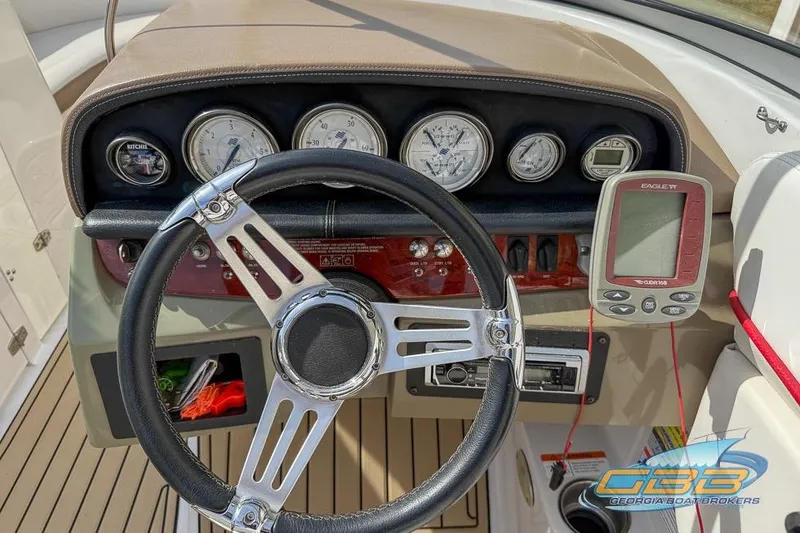 Slide: The Image of 2008 Four Winns F224 boat dashboard with steering wheel and gauges. - 14