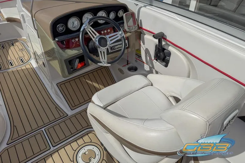 Slide: The Image of 2008 Four Winns F224 boat interior with steering wheel and dashboard controls. - 15