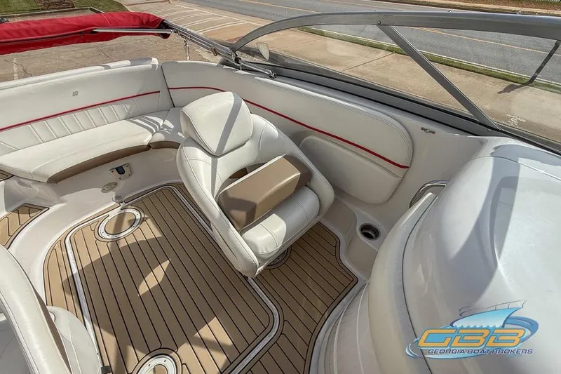 Slide: The Image of 2008 Four Winns F224 boat interior with white seating and wood-style flooring. - 16