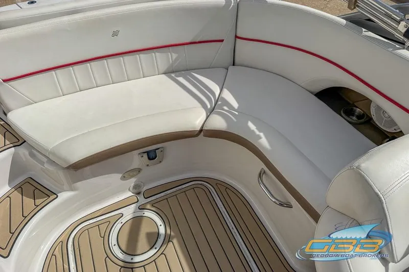 Slide: The Image of 2008 Four Winns F224 boat interior with white seating and teak-style flooring. - 17