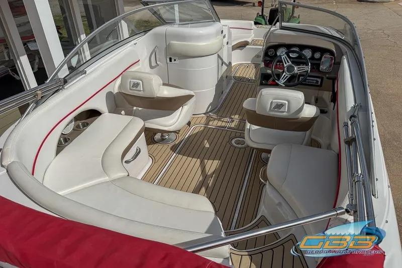 Slide: The Image of 2008 Four Winns F224 boat interior with plush seating and modern dashboard design. - 18