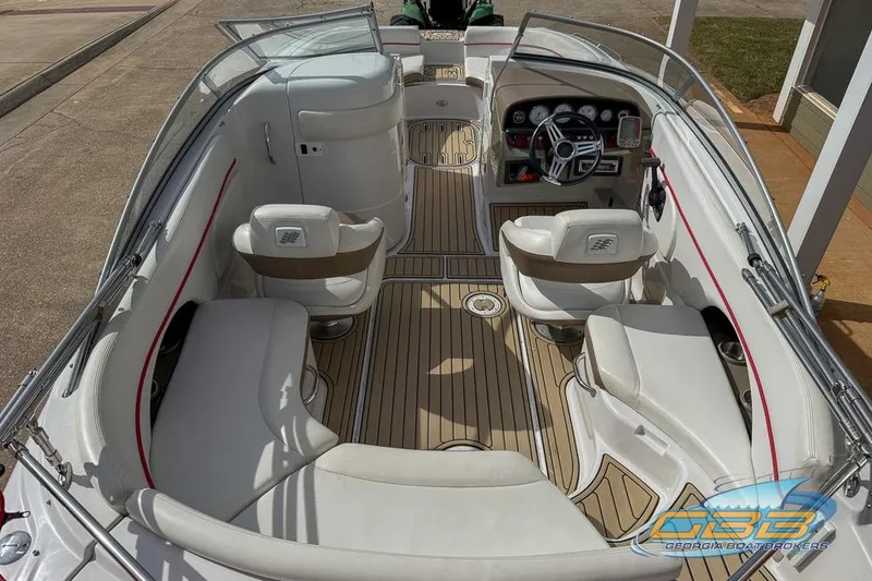 Slide: The Image of 2008 Four Winns F224 boat interior with white seating and wood-style flooring. - 2
