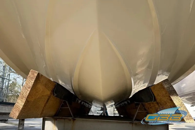 Slide: The Image of 2008 Four Winns F224 boat hull on wooden supports, viewed from below. - 22