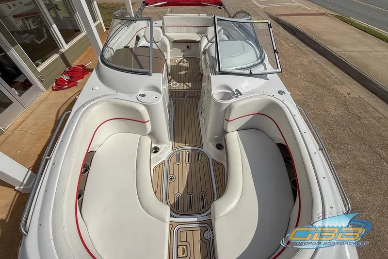 Slide: The Image of 2008 Four Winns F224 boat interior with white seating and wood flooring. - 3