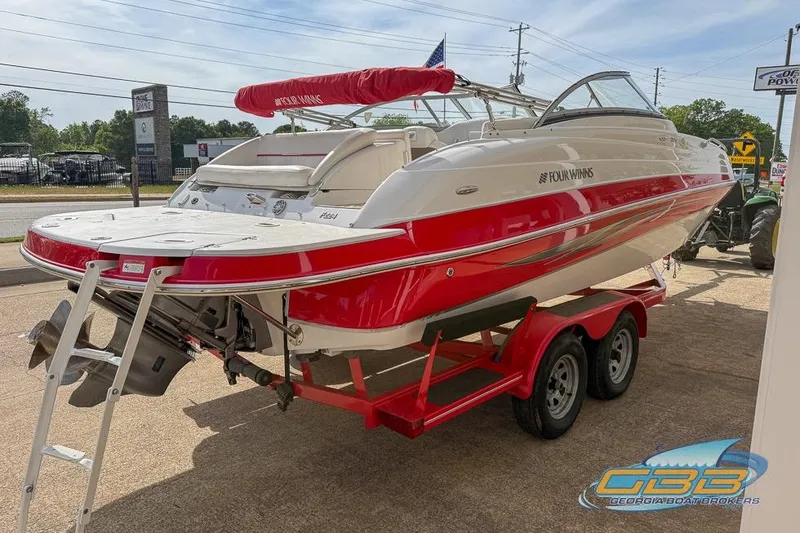 Slide: The Image of 2008 Four Winns F224 boat on trailer, red and white design, parked outdoors. - 8