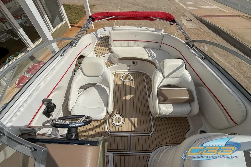 Slide: The Image of 2008 Four Winns F224 boat interior with white seating and wood flooring. - 9