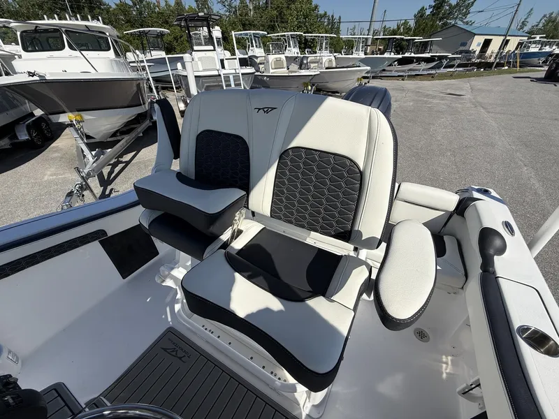 Slide: The Image of 2026 Tidewater 210 LXF boat seat with padded armrests. - 4