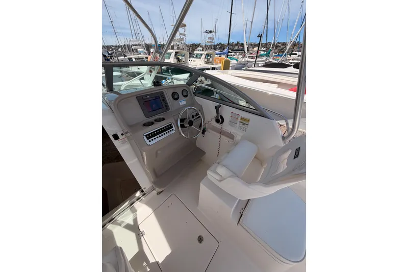 Slide: The Image of 2008 Robalo R225 Walkaround boat cockpit with steering wheel and control panel. - 13