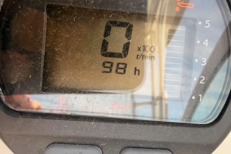 Slide: The Image of Close-up of a 2008 Robalo R225 Walkaround boat tachometer showing 98 hours. - 15