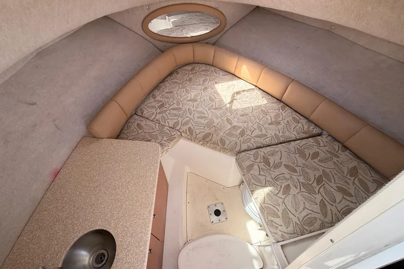 Slide: The Image of Interior cabin of 2008 Robalo R225 Walkaround boat with cushioned seating and compact sink. - 19
