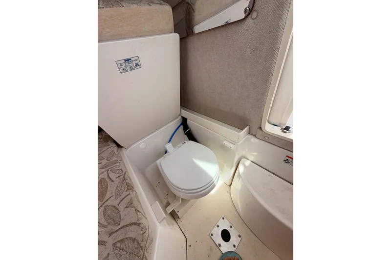 Slide: The Image of 2008 Robalo R225 Walkaround boat interior with compact marine toilet. - 22