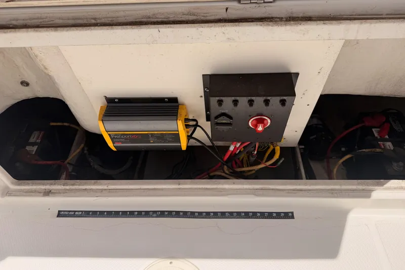 Slide: The Image of Electrical panel and battery charger in a 2008 Robalo R225 Walkaround boat. - 26