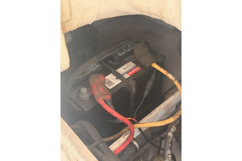 Slide: The Image of Battery compartment of a 2008 Robalo R225 Walkaround boat with visible cables. - 27