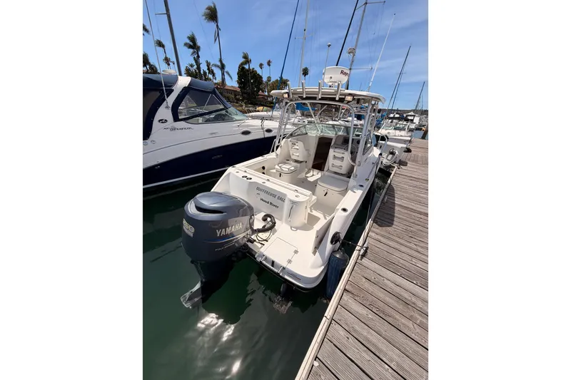 Slide: The Image of 2008 Robalo R225 Walkaround boat docked with Yamaha outboard motor. - 6