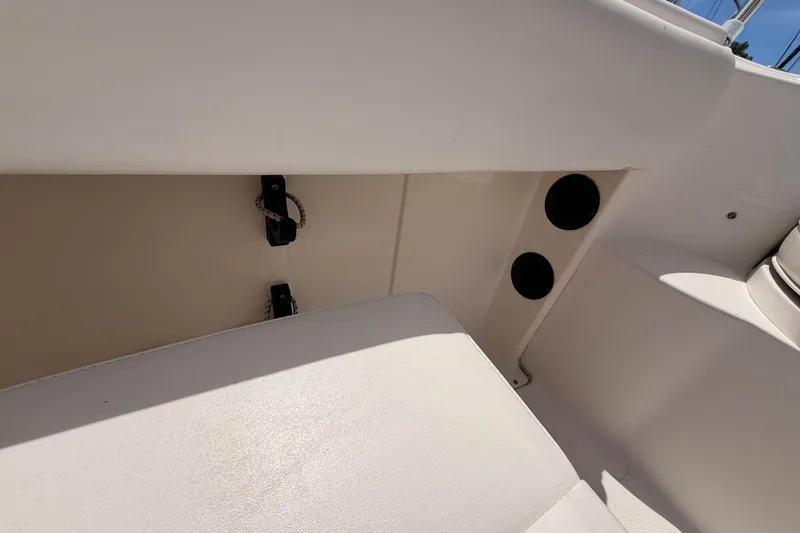 Slide: The Image of 2008 Robalo R225 Walkaround boat interior with seating and storage compartments. - 9
