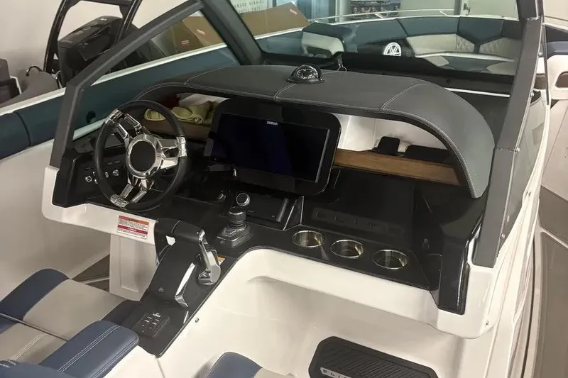 Slide: The Image of 2025 Monterey Elite 30 OB boat interior with modern dashboard and steering wheel. - 11