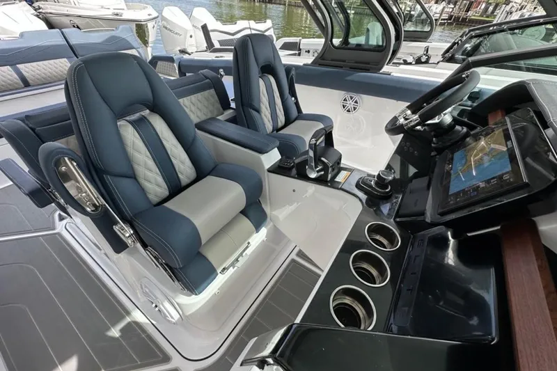 Slide: The Image of Luxurious interior of 2025 Monterey Elite 30 OB boat with modern seating and navigation system. - 13