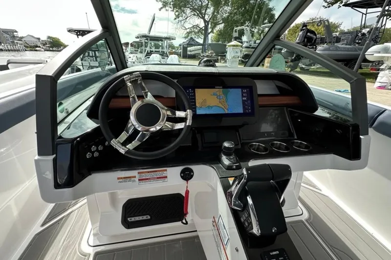 Slide: The Image of 2025 Monterey Elite 30 OB boat dashboard with steering wheel and navigation display. - 14