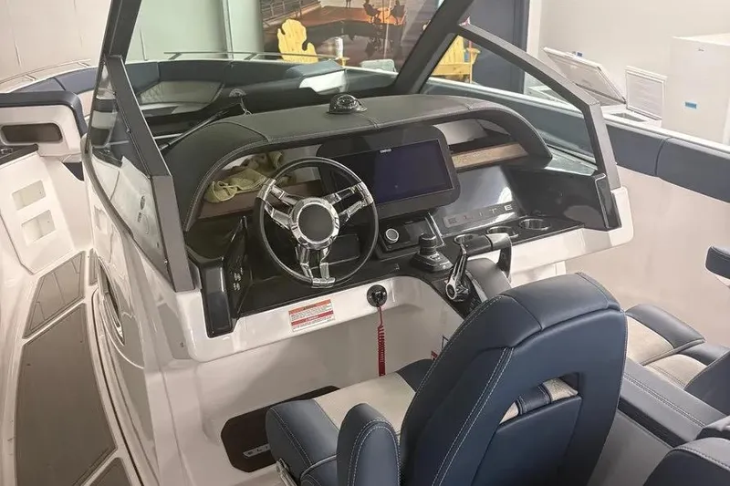 Slide: The Image of 2025 Monterey Elite 30 OB boat interior with modern dashboard and steering wheel. - 3