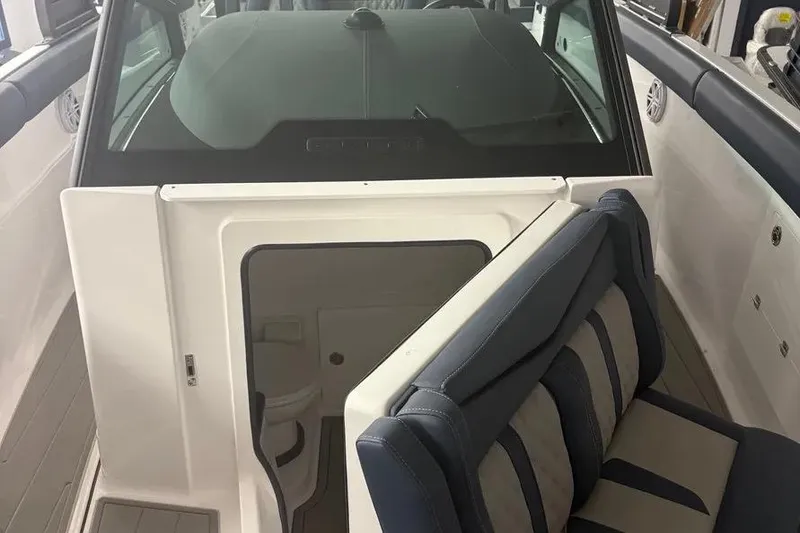 Slide: The Image of 2025 Monterey Elite 30 OB boat interior with seating and cabin entrance. - 6