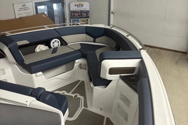 Slide: The Image of 2025 Monterey Elite 30 OB boat interior with blue and gray seating. - 8