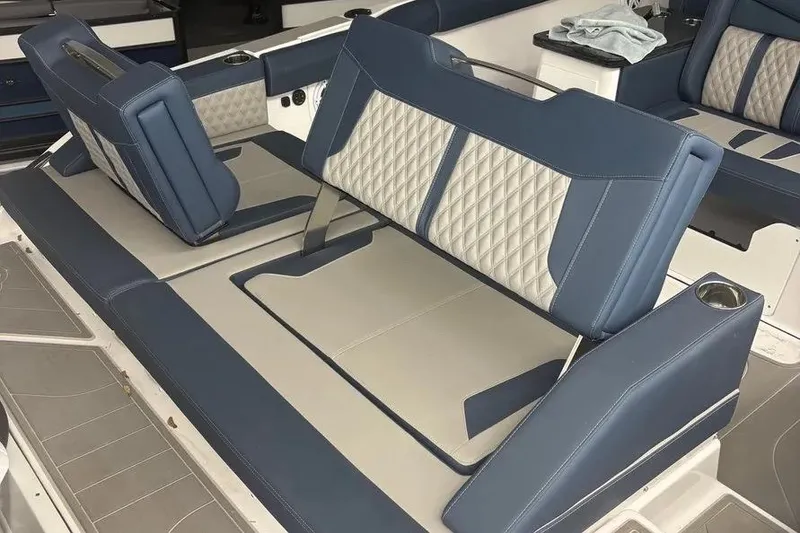 Slide: The Image of Luxurious seating on 2025 Monterey Elite 30 OB boat with blue and gray upholstery. - 9