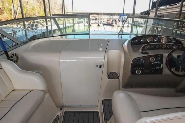 Slide: The Image of 1999 Rinker Fiesta Vee 330 boat cockpit with steering wheel and control panel. - 19