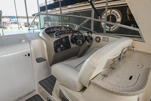 Slide: The Image of 1999 Rinker Fiesta Vee 330 boat cockpit with steering wheel and control panel. - 20