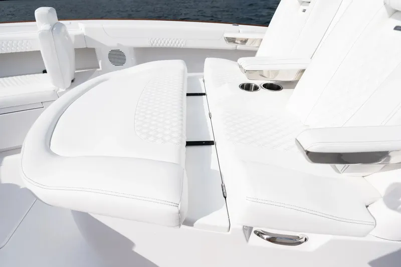 Slide: The Image of Manufacturer Provided Image: Luxurious white seating on 2025 Phenom 37 boat, featuring cup holders and elegant design. - 10
