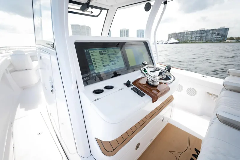 Slide: The Image of Manufacturer Provided Image: Phenom 37 boat dashboard with advanced navigation system, 2025 model, on a sunny day. - 11