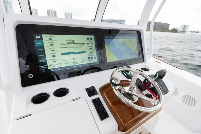 Slide: The Image of Manufacturer Provided Image: Phenom 37 boat dashboard with advanced navigation system, 2025 model, on open water. - 12