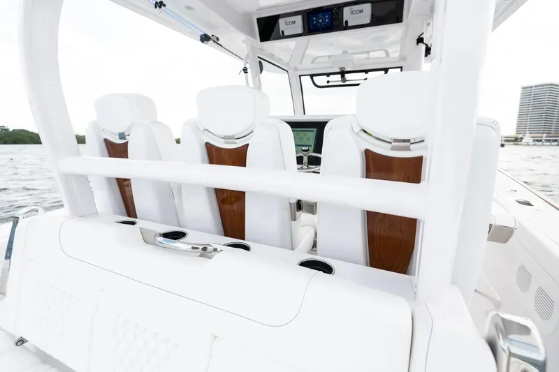 Slide: The Image of Manufacturer Provided Image: Luxury seating on 2025 Phenom 37 boat, featuring sleek white and wood design. - 16